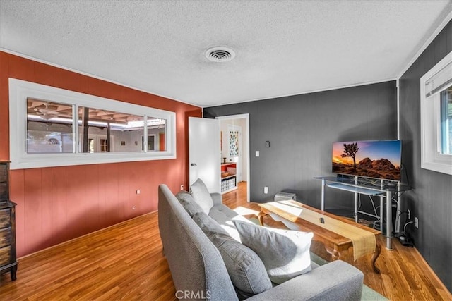 56772 Kismet Rd, Yucca Valley, CA 92284 - living room featuring wood finished floors, a textured ceiling, and wood walls