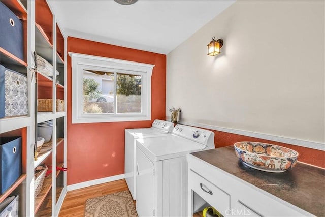 56772 Kismet Rd, Yucca Valley, CA 92284 - washroom with washing machine and clothes dryer, light wood-style floors, and baseboards