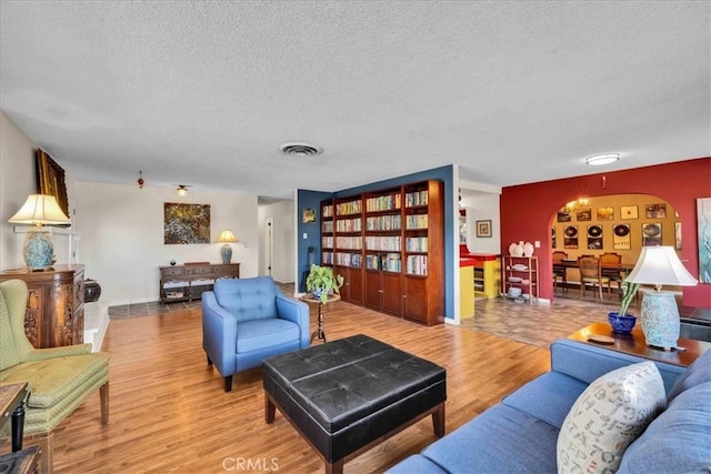 56772 Kismet Rd, Yucca Valley, CA 92284 - living area featuring wood finished floors, a textured ceiling, and baseboards