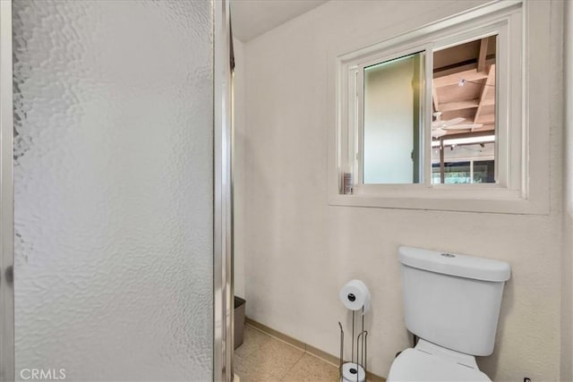 56772 Kismet Rd, Yucca Valley, CA 92284 - bathroom featuring toilet, baseboards, and a shower