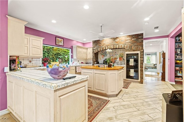 4960 Densmore Ave, Encino, CA 91436 - kitchen with a ceiling fan, tasteful backsplash, recessed lighting, crown molding, and a peninsula