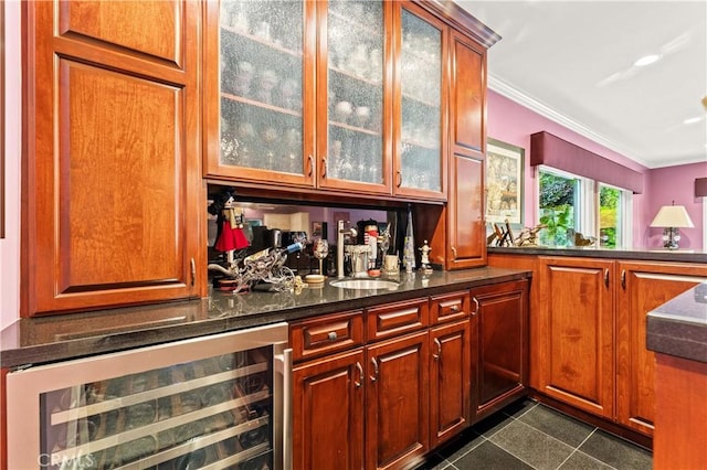 4960 Densmore Ave, Encino, CA 91436 - indoor wet bar featuring beverage cooler, ornamental molding, and dark tile patterned floors