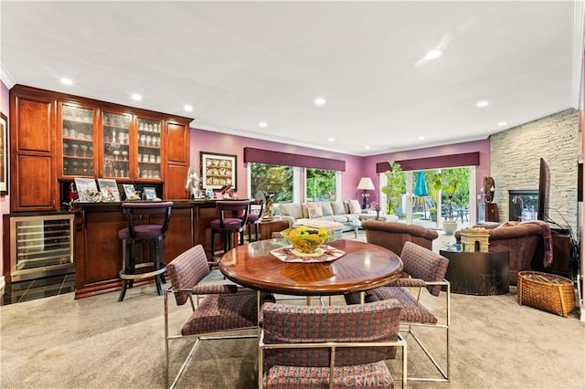 4960 Densmore Ave, Encino, CA 91436 - dining room featuring beverage cooler, a bar, light carpet, recessed lighting, and crown molding