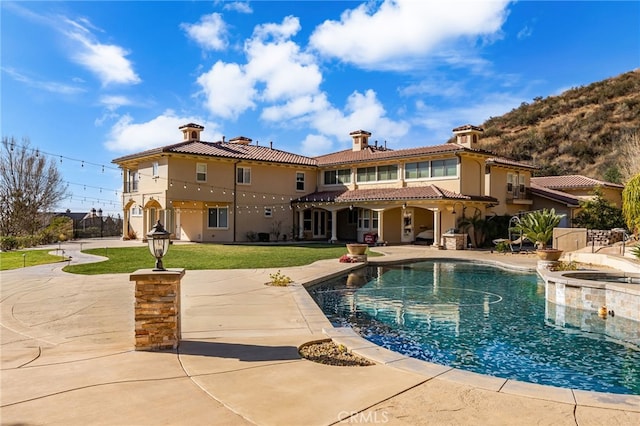 475 W 26th St, Upland, CA 91784 - back of property featuring a patio, a pool with connected hot tub, stucco siding, and a tile roof