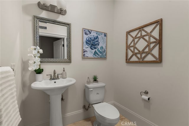 475 W 26th St, Upland, CA 91784 - bathroom with toilet, baseboards, and a sink