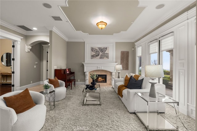 475 W 26th St, Upland, CA 91784 - living area with decorative columns, a large fireplace, baseboards, arched walkways, and crown molding