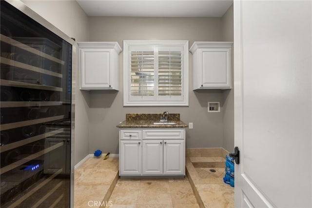 475 W 26th St, Upland, CA 91784 - laundry room featuring hookup for a washing machine, baseboards, wine cooler, and cabinet space