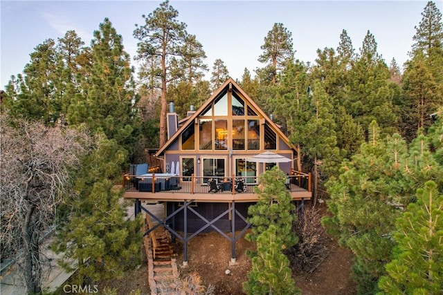 43620 Colusa Dr, Big Bear Lake, CA 92315 - back of house with a deck, a wooded view, and a chimney