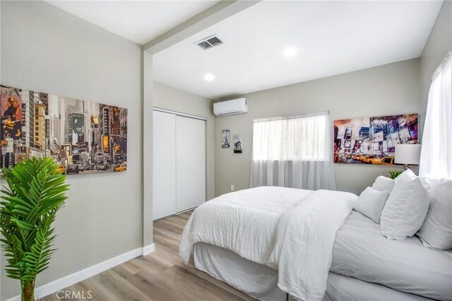 14907 S Raymond Ave, Gardena, CA 90247 - bedroom featuring a wall mounted air conditioner, wood finished floors, a closet, baseboards, and recessed lighting