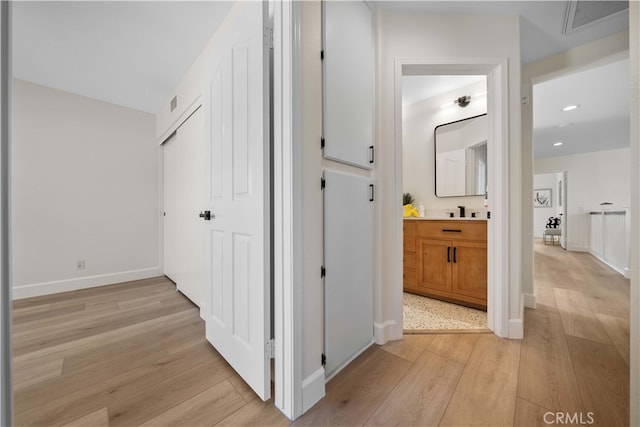 59 Cape Victoria, Aliso Viejo, CA 92656 - corridor with light wood-style floors, a sink, recessed lighting, and baseboards