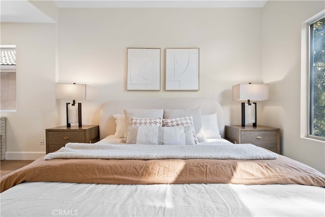 59 Cape Victoria, Aliso Viejo, CA 92656 - bedroom featuring multiple windows, baseboards, and wood finished floors