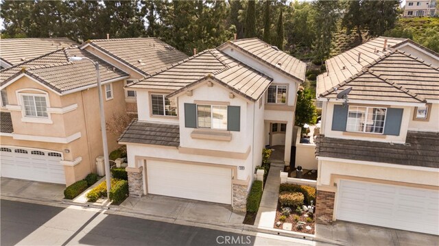 59 Cape Victoria, Aliso Viejo, CA 92656 - view of front of house featuring a garage, driveway, stucco siding, and a tiled roof
