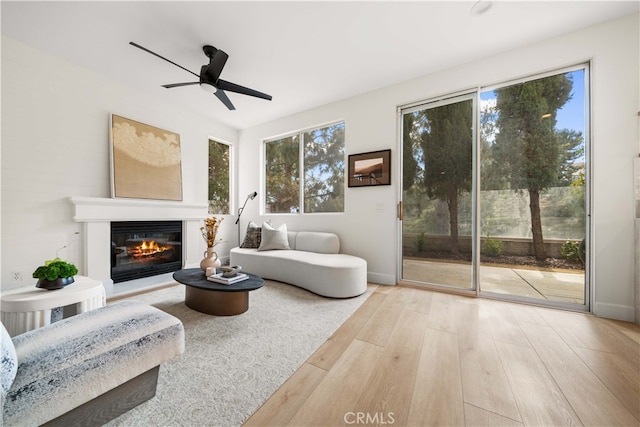 59 Cape Victoria, Aliso Viejo, CA 92656 - living area featuring healthy amount of natural light, wood finished floors, ceiling fan, and a glass covered fireplace