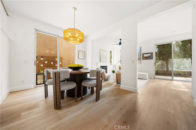 59 Cape Victoria, Aliso Viejo, CA 92656 - dining area featuring light wood-style floors, ceiling fan, a fireplace, and baseboards