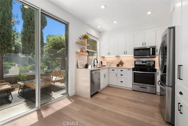 59 Cape Victoria, Aliso Viejo, CA 92656 - kitchen with stainless steel appliances, light wood-style flooring, recessed lighting, decorative backsplash, and light countertops