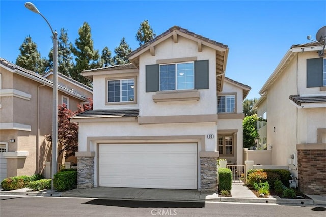 59 Cape Victoria, Aliso Viejo, CA 92656 - traditional-style house featuring an attached garage, stucco siding, a tile roof, and stone siding
