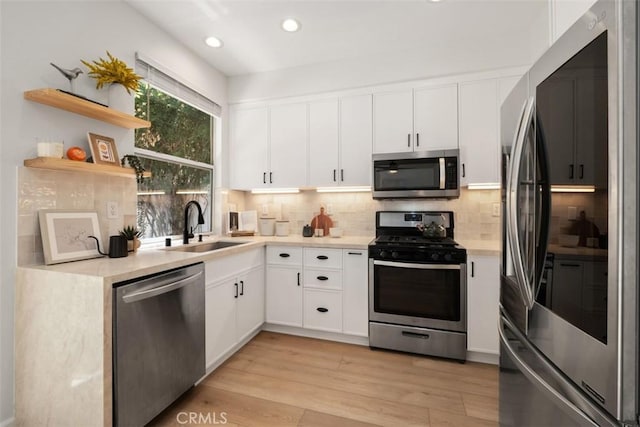 59 Cape Victoria, Aliso Viejo, CA 92656 - kitchen featuring stainless steel appliances, light countertops, backsplash, light wood-style floors, and recessed lighting