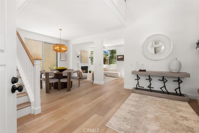 59 Cape Victoria, Aliso Viejo, CA 92656 - foyer featuring stairs, light wood-type flooring, and a lit fireplace