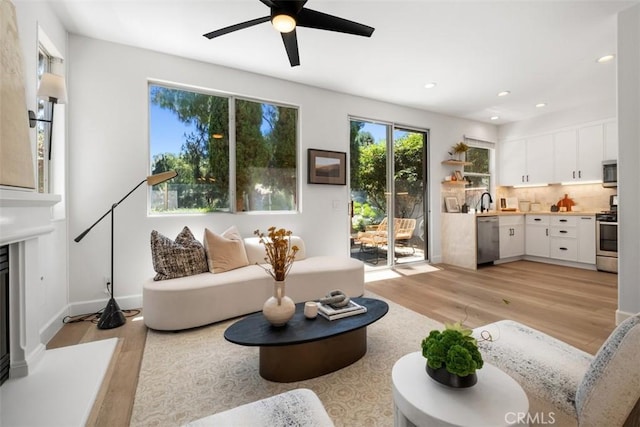 59 Cape Victoria, Aliso Viejo, CA 92656 - living room featuring light wood-style floors, ceiling fan, recessed lighting, and a glass covered fireplace