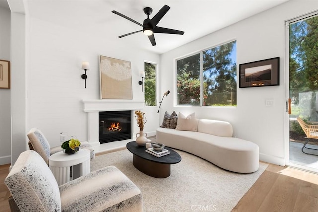 59 Cape Victoria, Aliso Viejo, CA 92656 - living room featuring wood finished floors, a glass covered fireplace, and a ceiling fan
