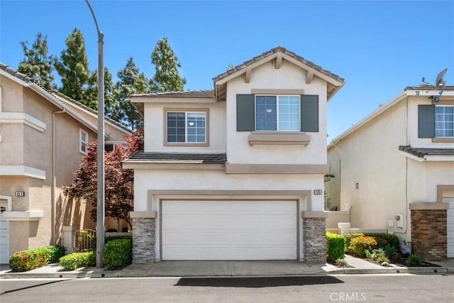 59 Cape Victoria, Aliso Viejo, CA 92656 - traditional home with stucco siding, a garage, stone siding, driveway, and a tiled roof