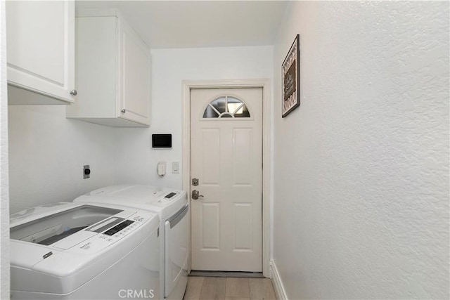 2546 N Orange Hill Ln, Orange, CA 92867 - clothes washing area with cabinet space, washing machine and clothes dryer, light wood finished floors, a textured wall, and baseboards