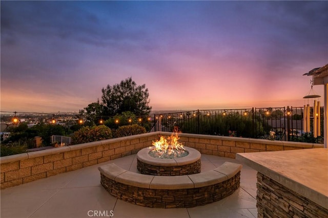 2546 N Orange Hill Ln, Orange, CA 92867 - patio terrace at dusk featuring an outdoor fire pit and fence