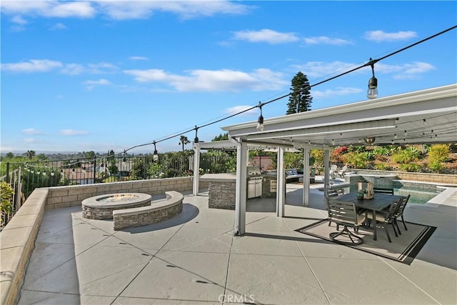 2546 N Orange Hill Ln, Orange, CA 92867 - view of patio / terrace with an outdoor fire pit, fence, an outdoor kitchen, and a pool with connected hot tub
