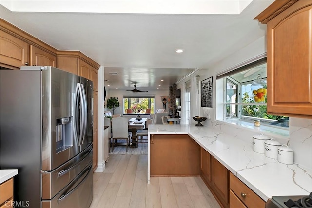 2546 N Orange Hill Ln, Orange, CA 92867 - kitchen featuring stainless steel refrigerator with ice dispenser, brown cabinetry, light stone counters, open floor plan, and light wood finished floors