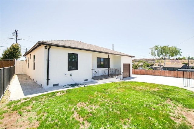 1336 W 118th St, Los Angeles, CA 90044 - back of property with a patio area, stucco siding, and an attached garage