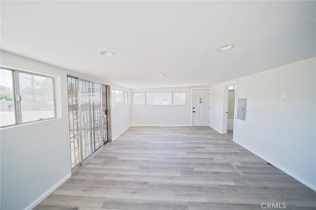 1336 W 118th St, Los Angeles, CA 90044 - spare room featuring baseboards, electric panel, light wood finished floors, and recessed lighting