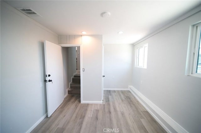 1336 W 118th St, Los Angeles, CA 90044 - empty room with light wood finished floors, baseboards, recessed lighting, stairway, and a smoke detector