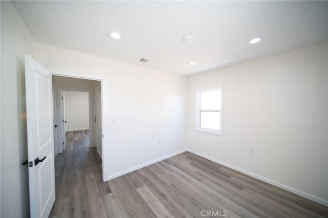 1336 W 118th St, Los Angeles, CA 90044 - unfurnished room with wood finished floors, recessed lighting, and baseboards