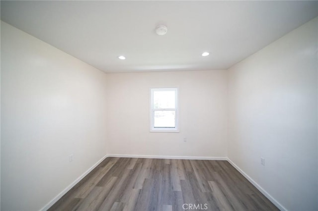 1336 W 118th St, Los Angeles, CA 90044 - spare room with wood finished floors, baseboards, recessed lighting, and a smoke detector