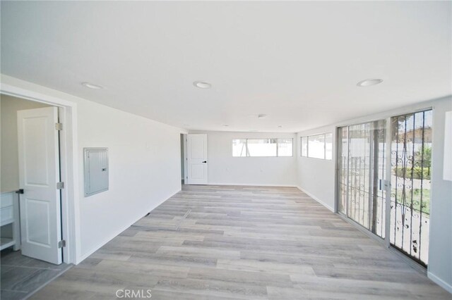 1336 W 118th St, Los Angeles, CA 90044 - empty room featuring electric panel, recessed lighting, light wood-type flooring, and baseboards