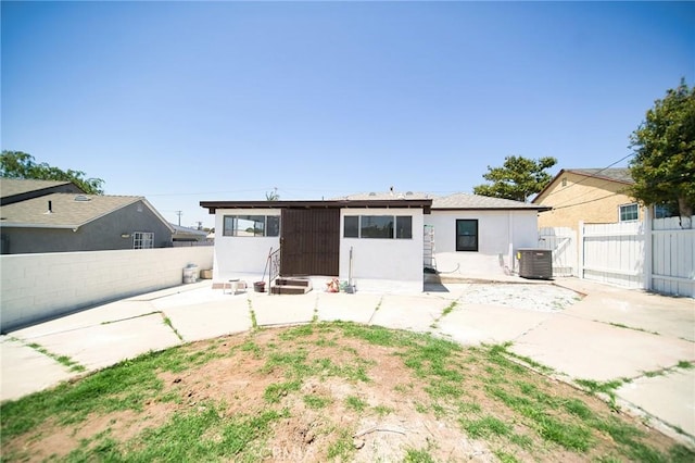 1336 W 118th St, Los Angeles, CA 90044 - rear view of property featuring entry steps, cooling unit, a patio area, and a fenced backyard