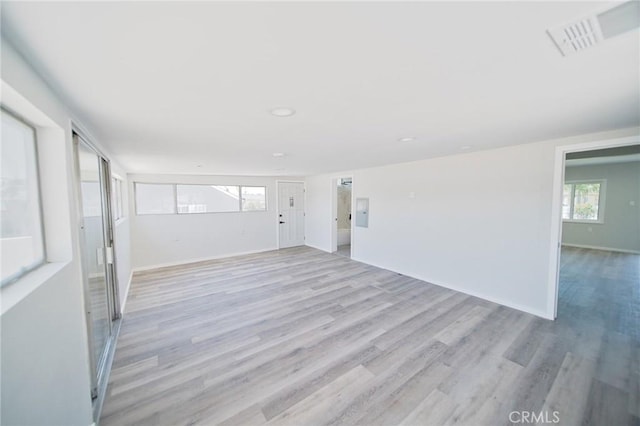 1336 W 118th St, Los Angeles, CA 90044 - empty room featuring light wood-style flooring, plenty of natural light, recessed lighting, and baseboards