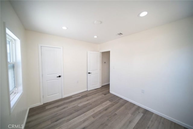 1336 W 118th St, Los Angeles, CA 90044 - unfurnished bedroom featuring wood finished floors, baseboards, and recessed lighting