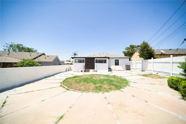 1336 W 118th St, Los Angeles, CA 90044 - back of property featuring a patio area, a fenced backyard, and central AC