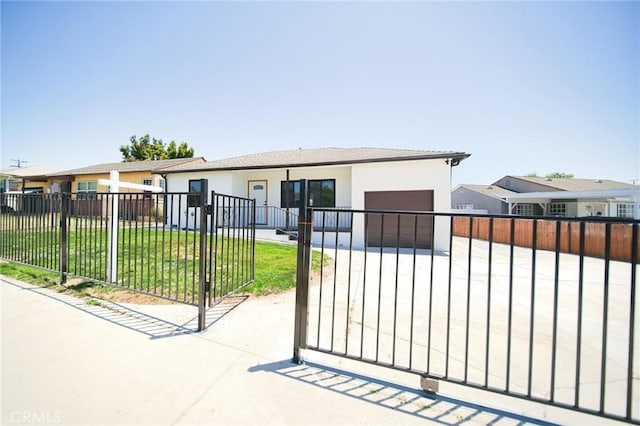 1336 W 118th St, Los Angeles, CA 90044 - view of front of home featuring an attached garage, stucco siding, concrete driveway, and a gate