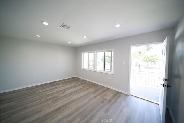 1336 W 118th St, Los Angeles, CA 90044 - empty room featuring wood finished floors, recessed lighting, and baseboards