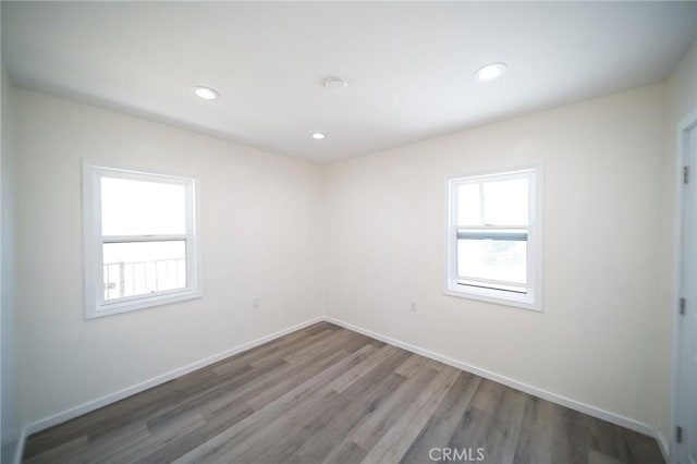 1336 W 118th St, Los Angeles, CA 90044 - empty room with wood finished floors, baseboards, and recessed lighting