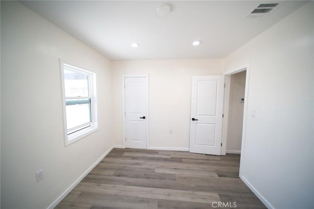 1336 W 118th St, Los Angeles, CA 90044 - unfurnished bedroom with wood finished floors, recessed lighting, and baseboards