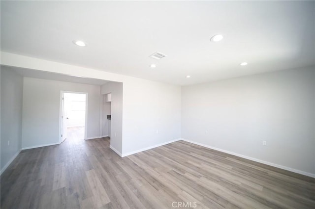 1336 W 118th St, Los Angeles, CA 90044 - spare room with wood finished floors, baseboards, and recessed lighting