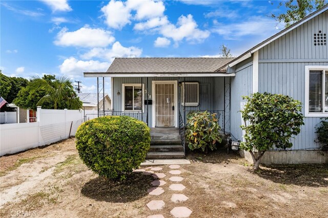 368 W St, Upland, CA 91786 - view of front facade with fence, covered porch, and a shingled roof