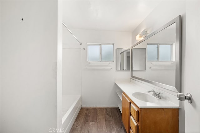 368 W St, Upland, CA 91786 - full bath with wood finished floors, vanity, baseboards, and shower / washtub combination