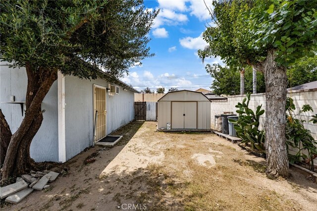 368 W St, Upland, CA 91786 - fenced backyard featuring a storage shed and an outdoor structure