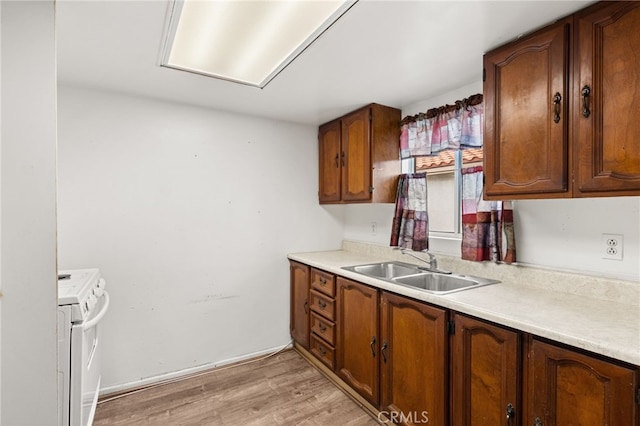 368 W St, Upland, CA 91786 - kitchen featuring white electric stove, a sink, light wood-style floors, and light countertops