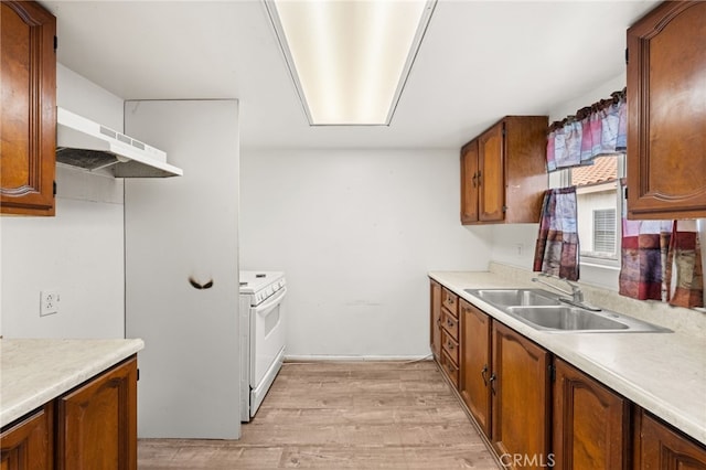 368 W St, Upland, CA 91786 - kitchen with a sink, under cabinet range hood, electric range, light wood-style floors, and light countertops