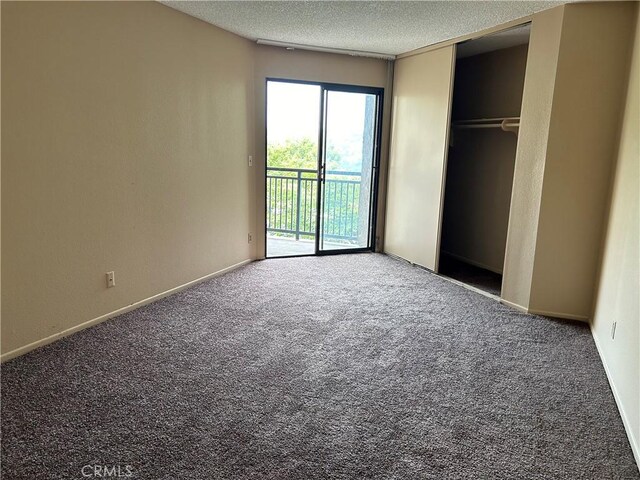 4499 Via Marisol Unit 327, Los Angeles, CA 90042 - unfurnished bedroom with access to outside, carpet, and a textured ceiling